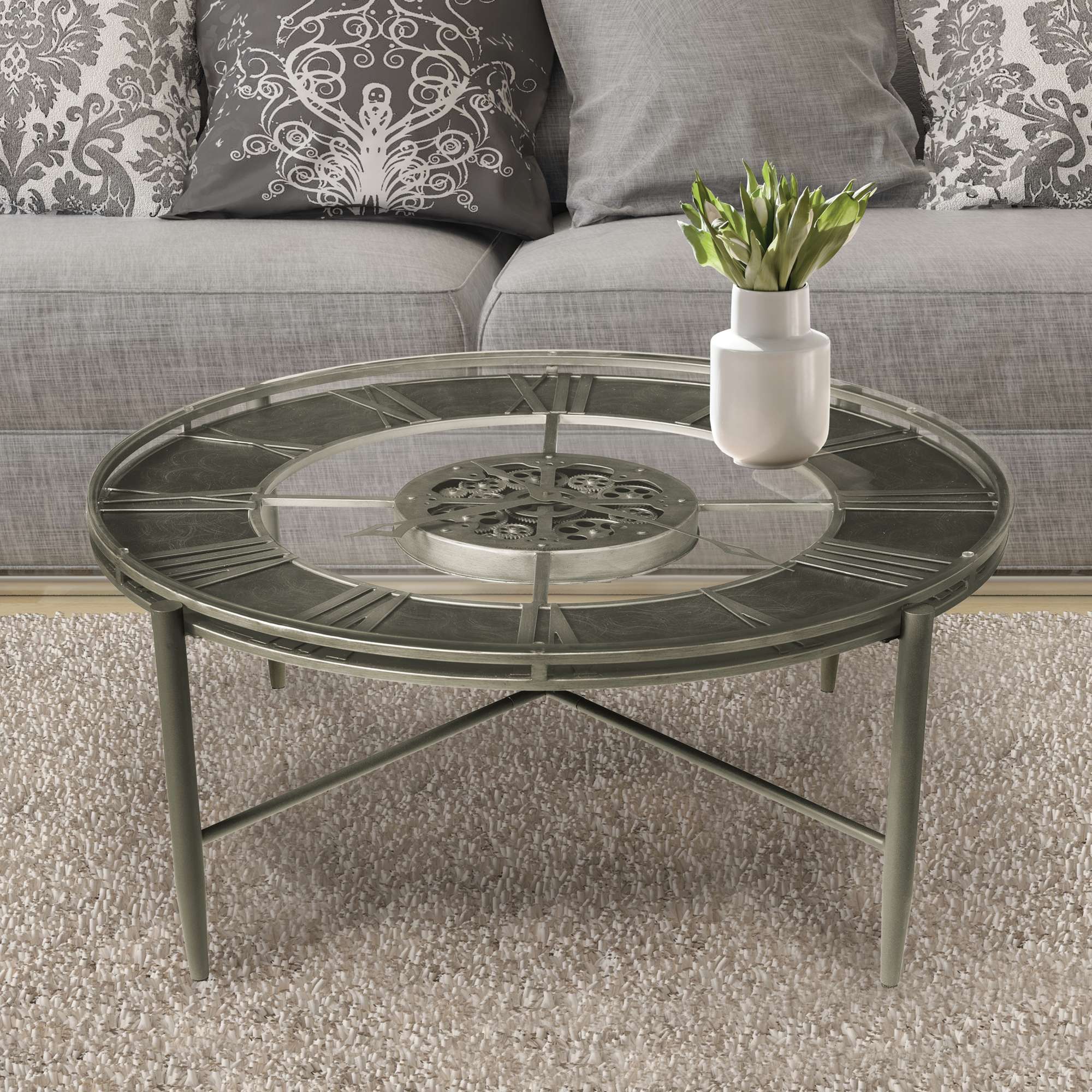 A decorative round coffee table with a metal frame and an intricate design, placed on a soft rug in a cozy living room setting.