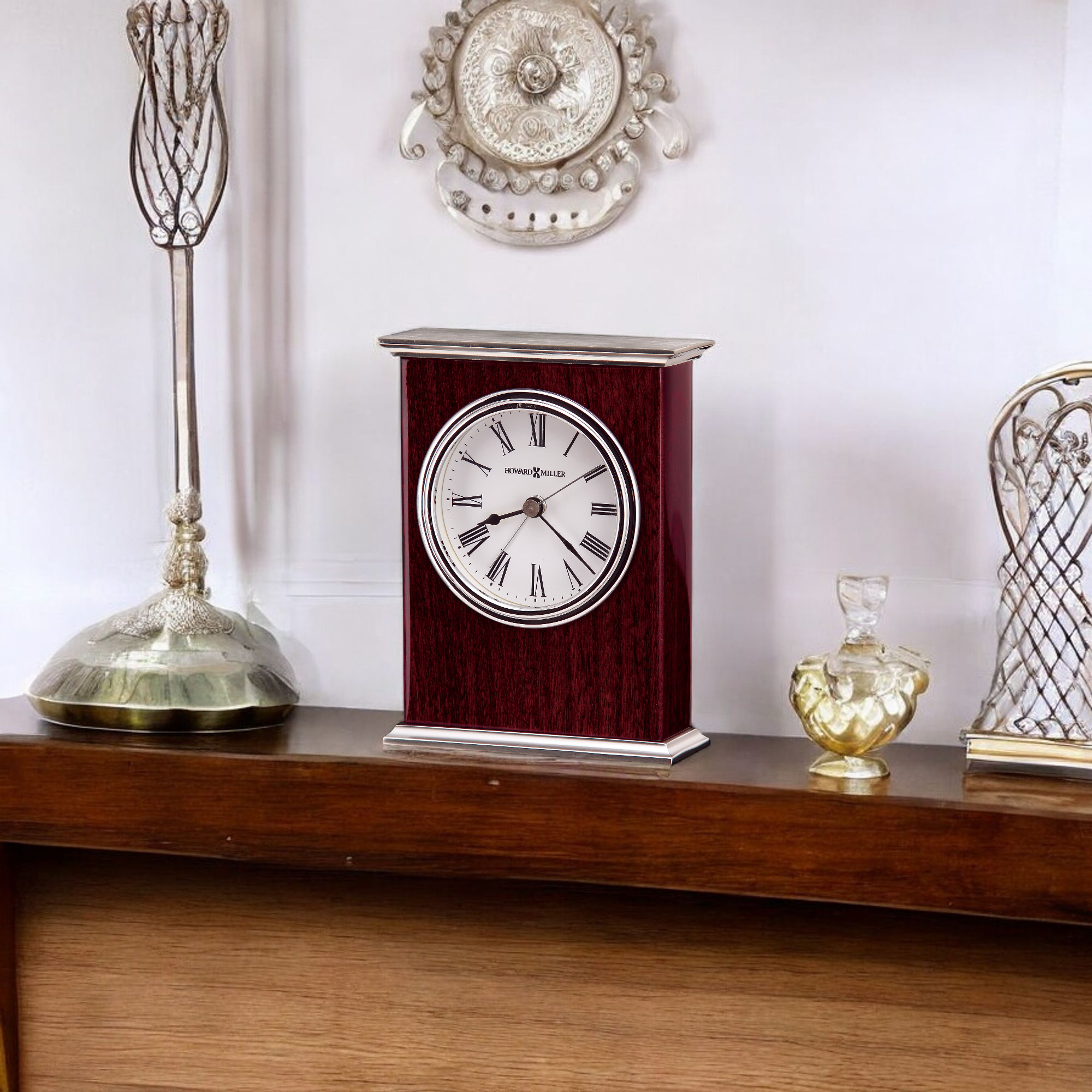 A decorative mantel clock on a wooden shelf, surrounded by vintage decor.