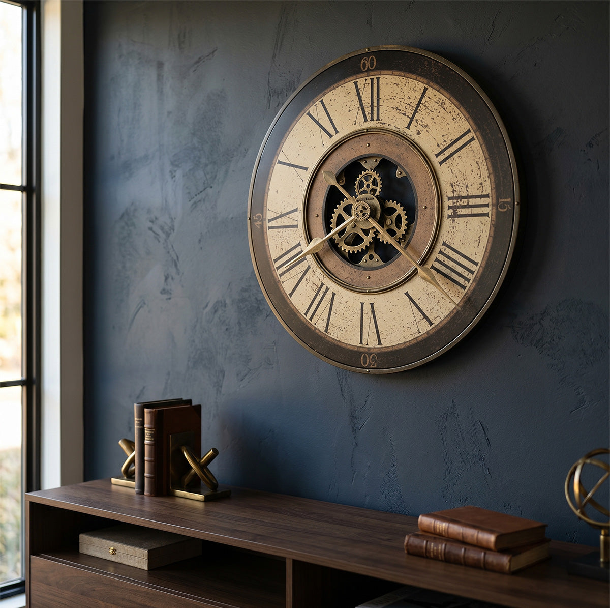 Decorative wall clock with mechanical design on a dark wall with a wooden shelf below.