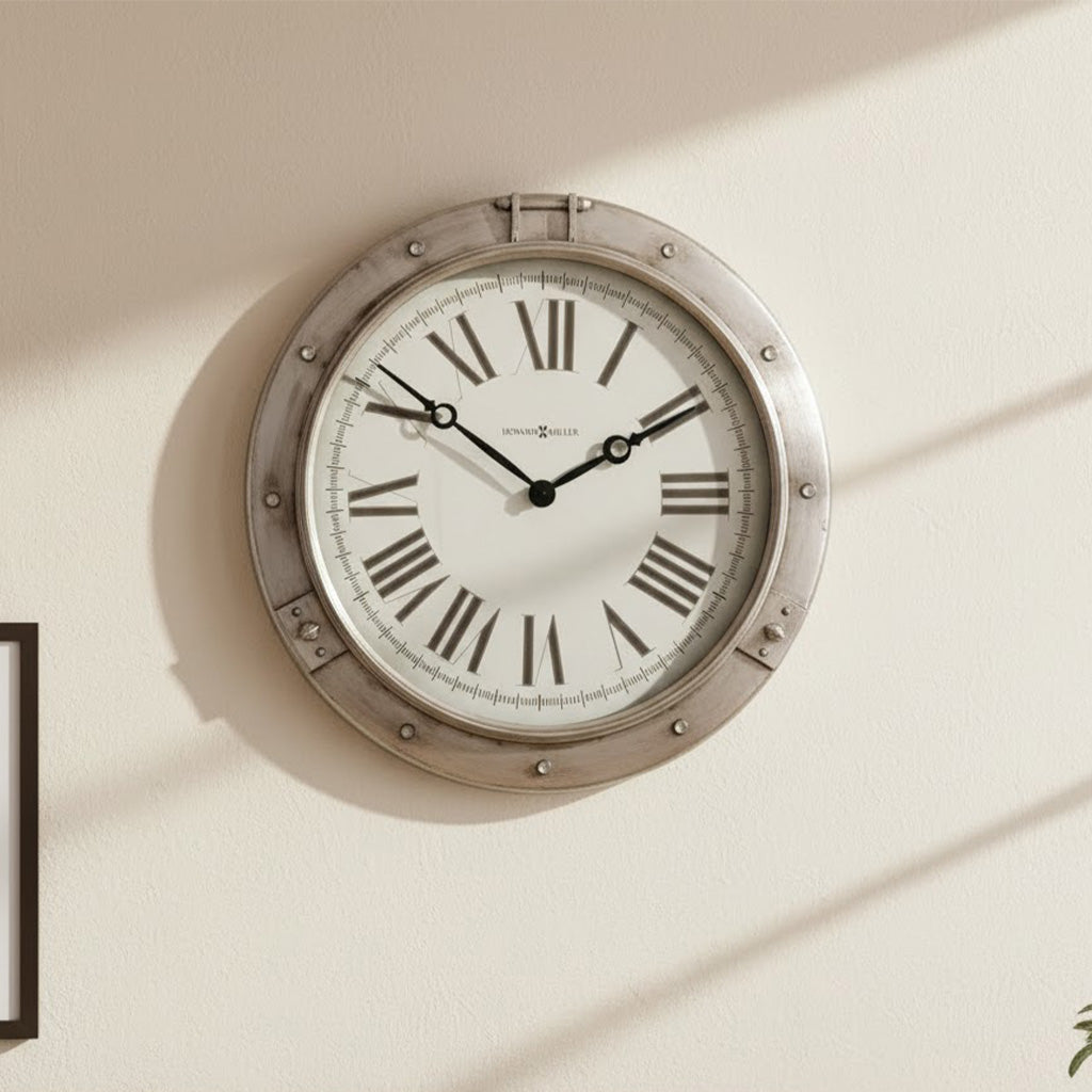 Silver vintage wall clock with Roman numerals and black hands, displaying elegant classic design.