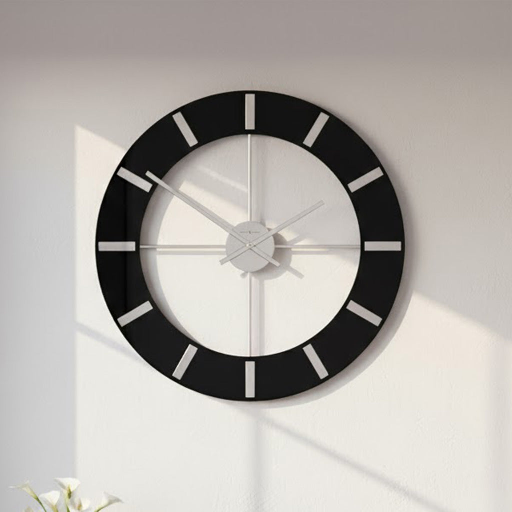Modern black wall clock with minimalist design and silver hands, perfect for home decor.