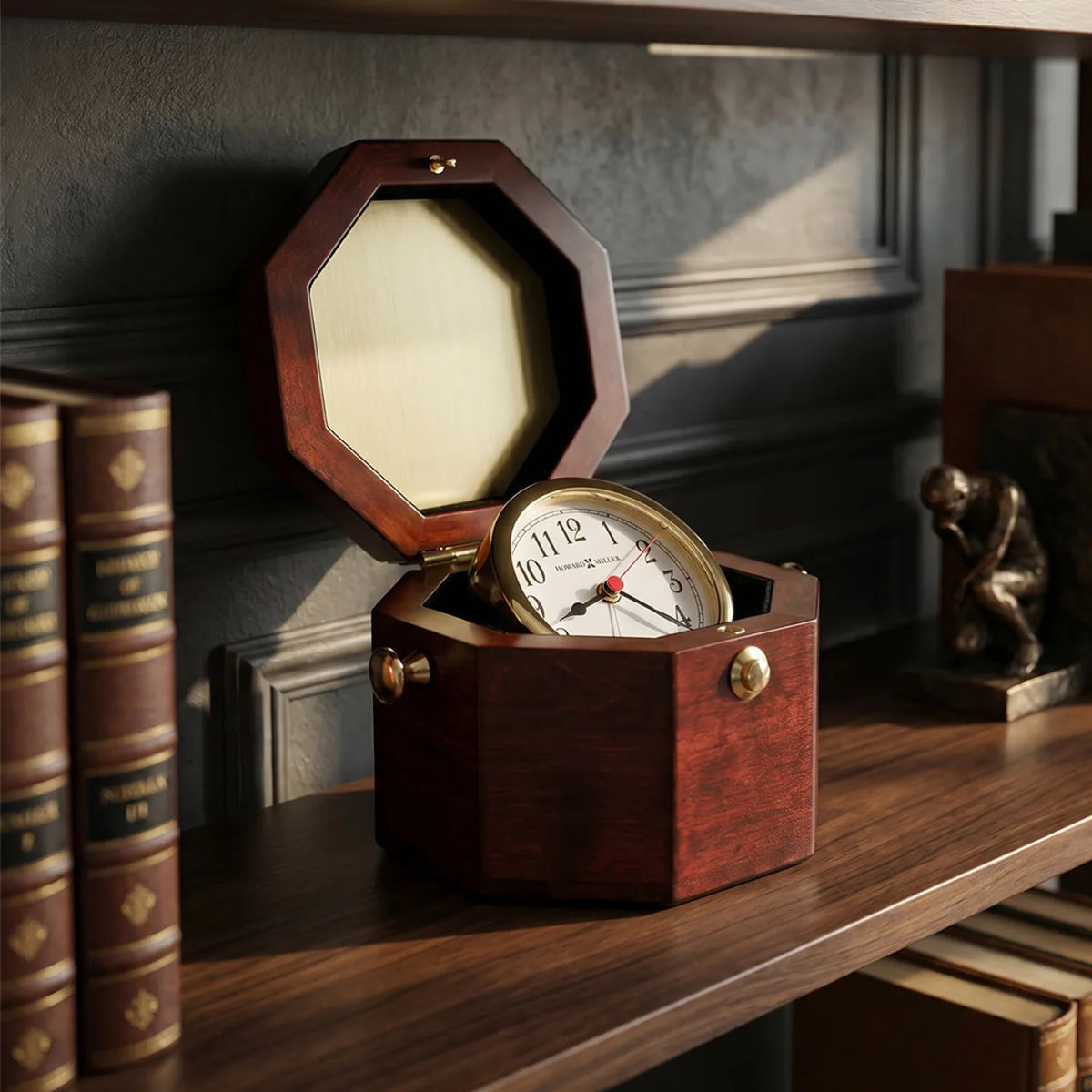 Howard Miller Chronometer Tabletop Clock, 7-inch, on a shelf in a styled room
