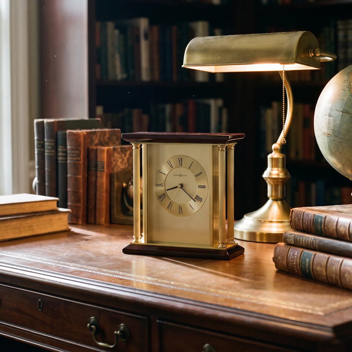 Howard Miller Carlton Tabletop Clock, 9-inch, on a shelf in a styled room