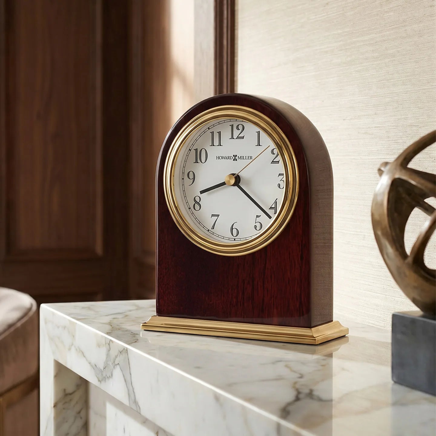 Howard Miller Monroe Tabletop Clock, 5-inch, on a shelf in a styled room