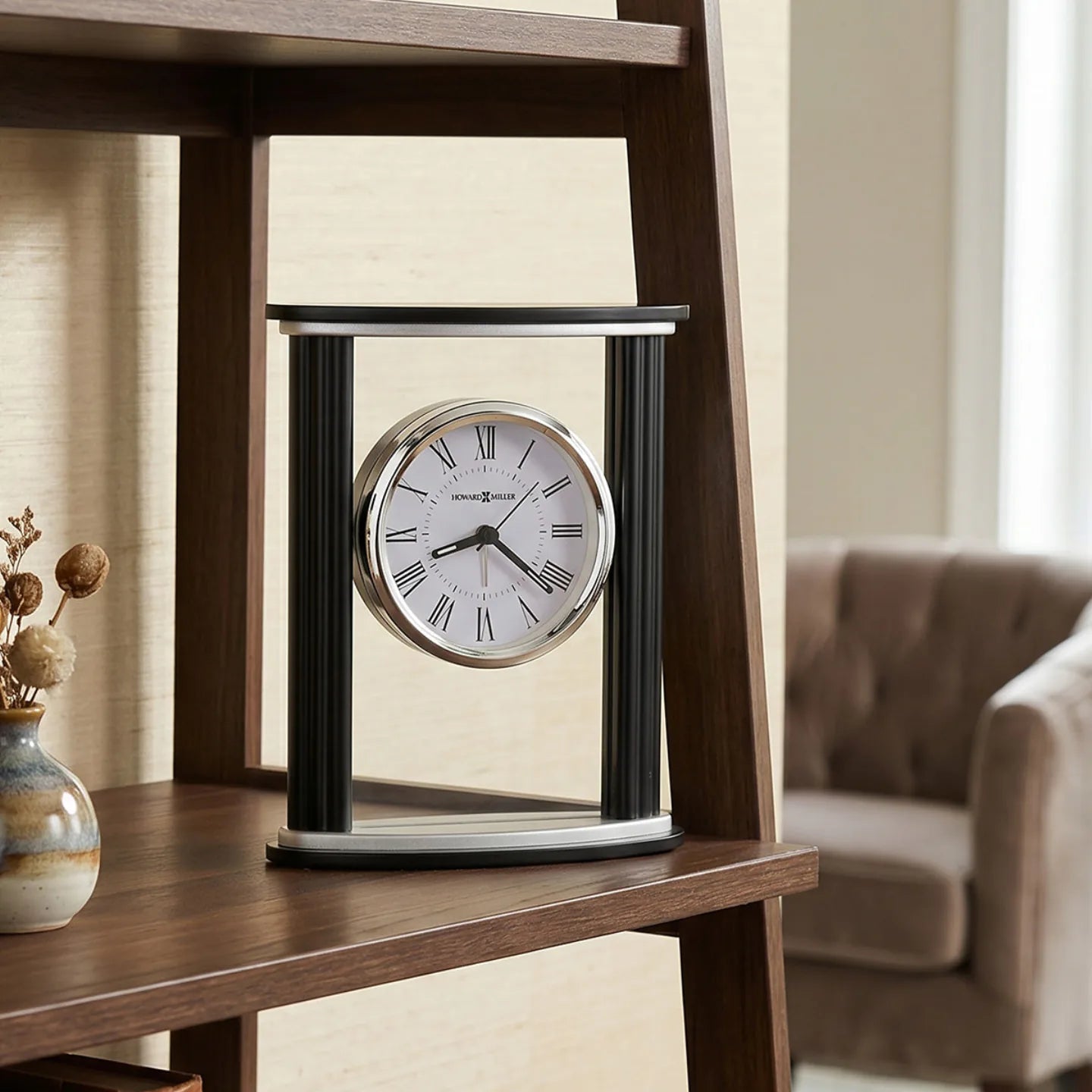 Howard Miller Cambridge Tabletop Clock, 7-inch, on a shelf in a styled room