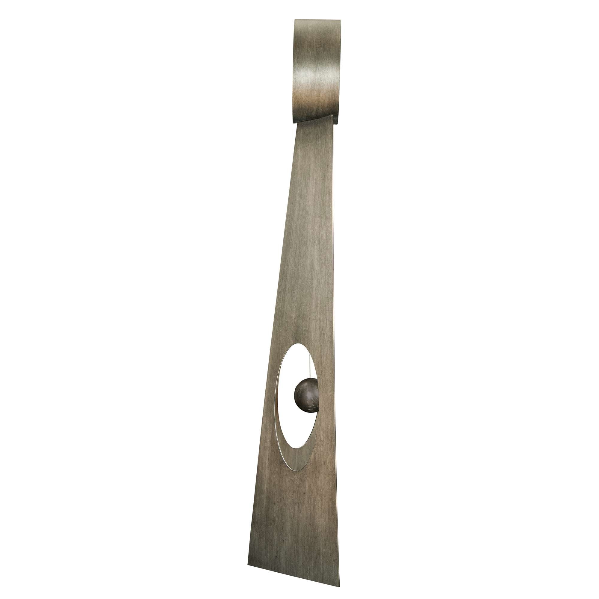 Abstract metal sculpture featuring a triangular shape with a circular opening and ball element.