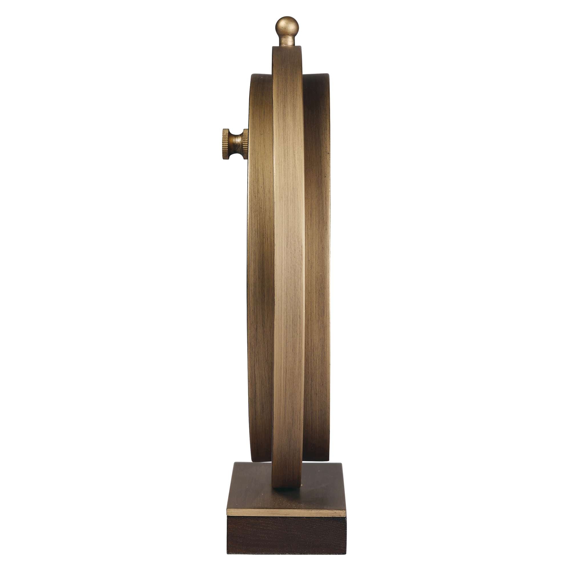 Side view of a decorative bronze wheel on a square base.