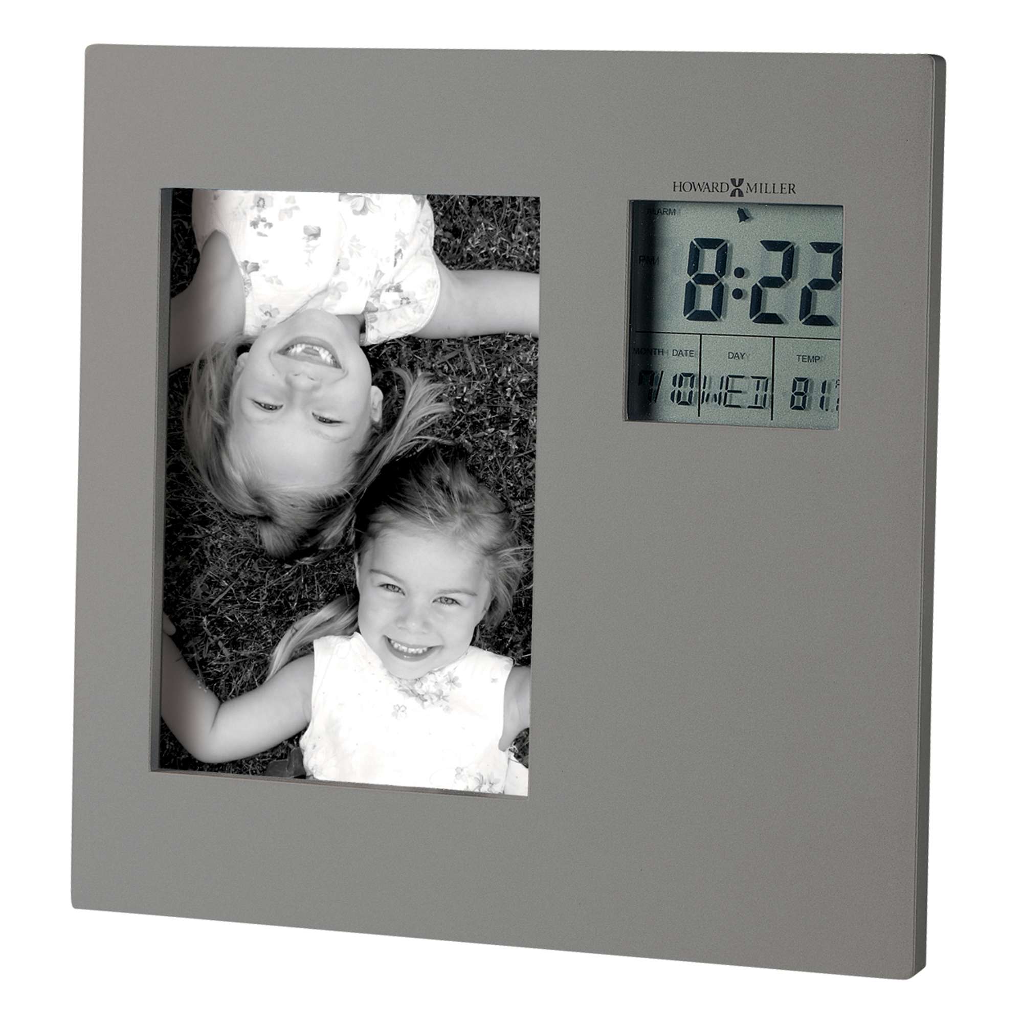 Digital photo frame displaying a picture of two smiling children and a clock.