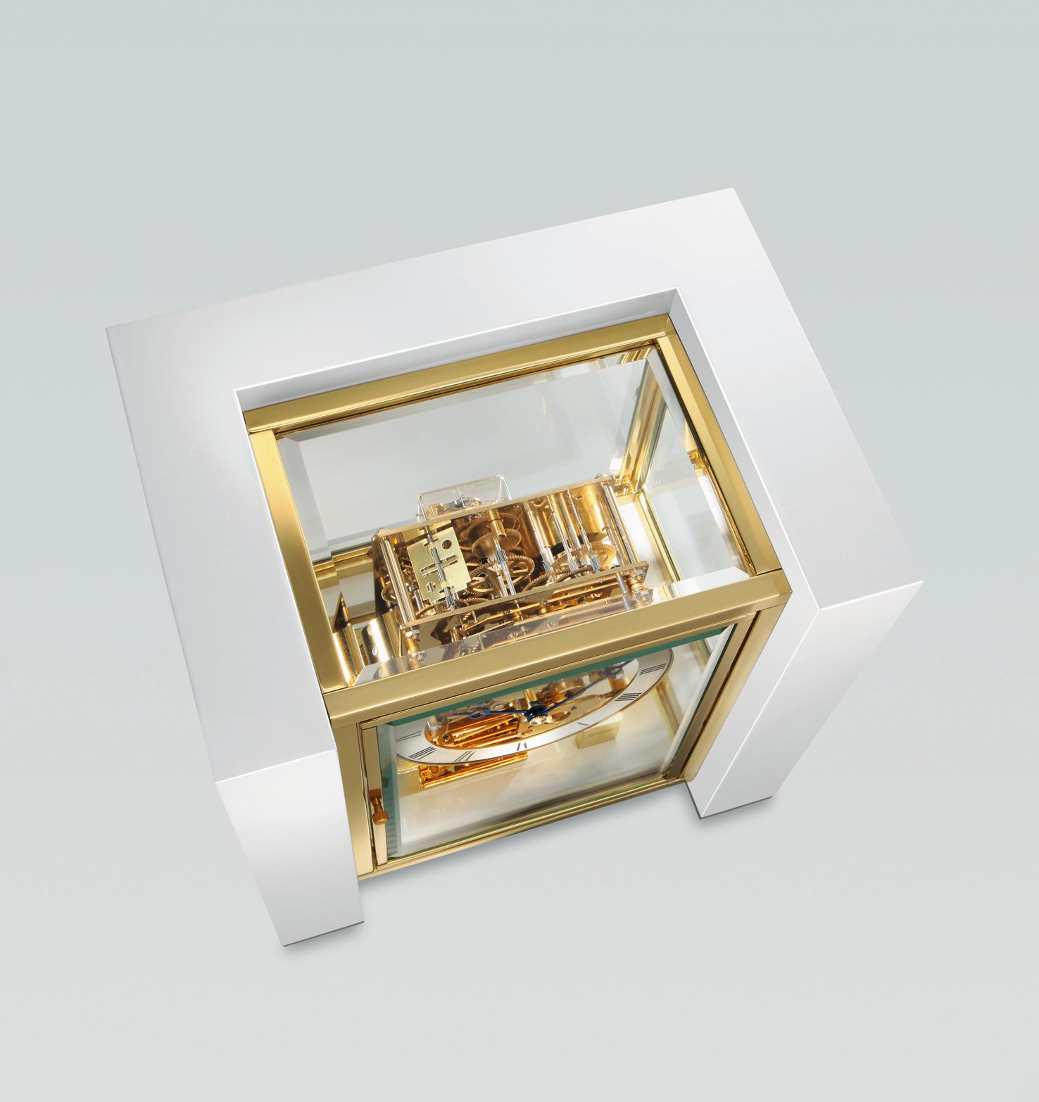 A luxurious gold-plated mechanical watch displayed in a glass case.