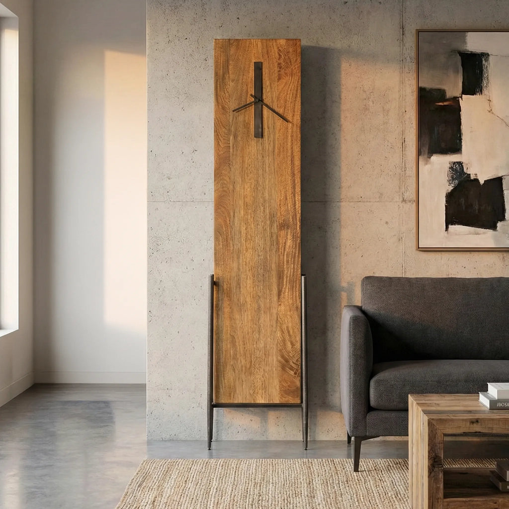 Tall wooden floor clock against a concrete wall in a modern living room.