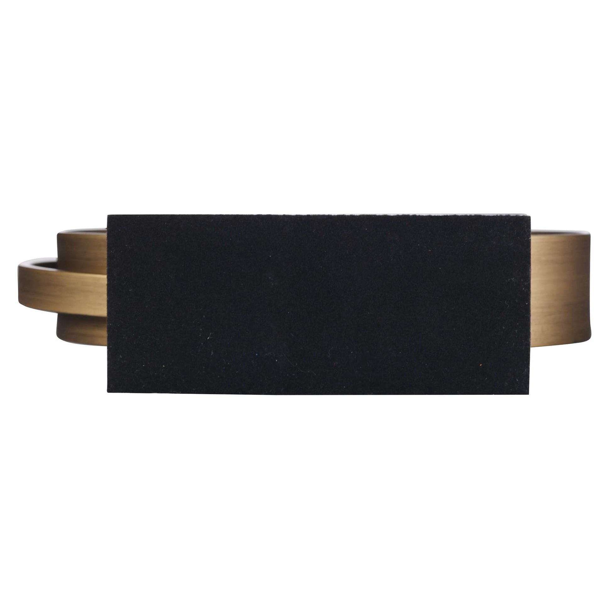 Abstract sculpture featuring a black rectangular shape and bronze accents