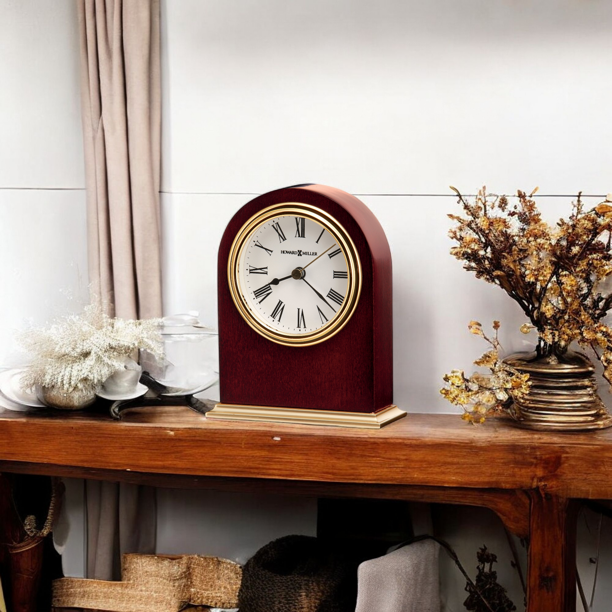 Vintage clock on a wooden shelf with dried flowers and decorative items.