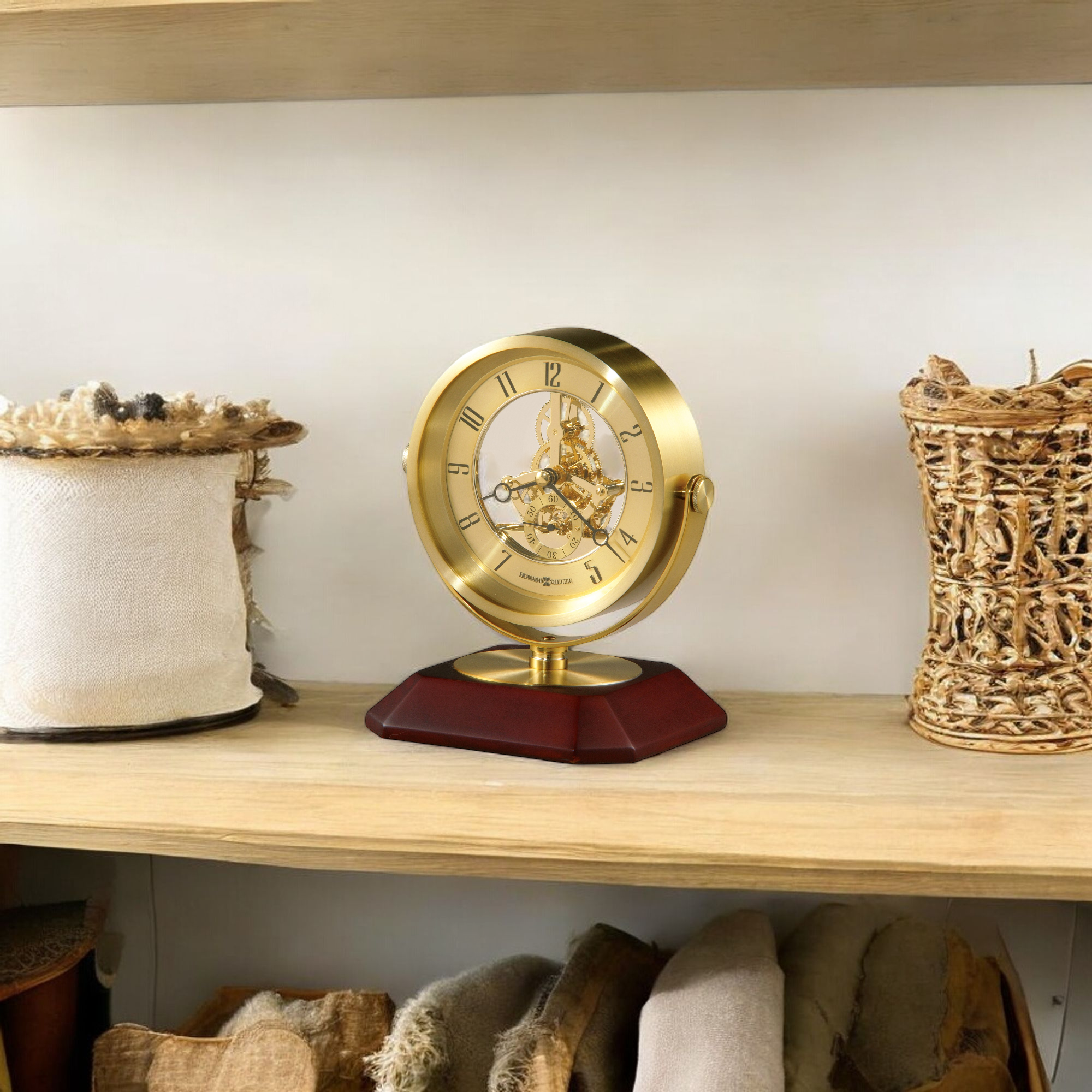 A decorative gold clock on a wooden shelf surrounded by woven baskets.