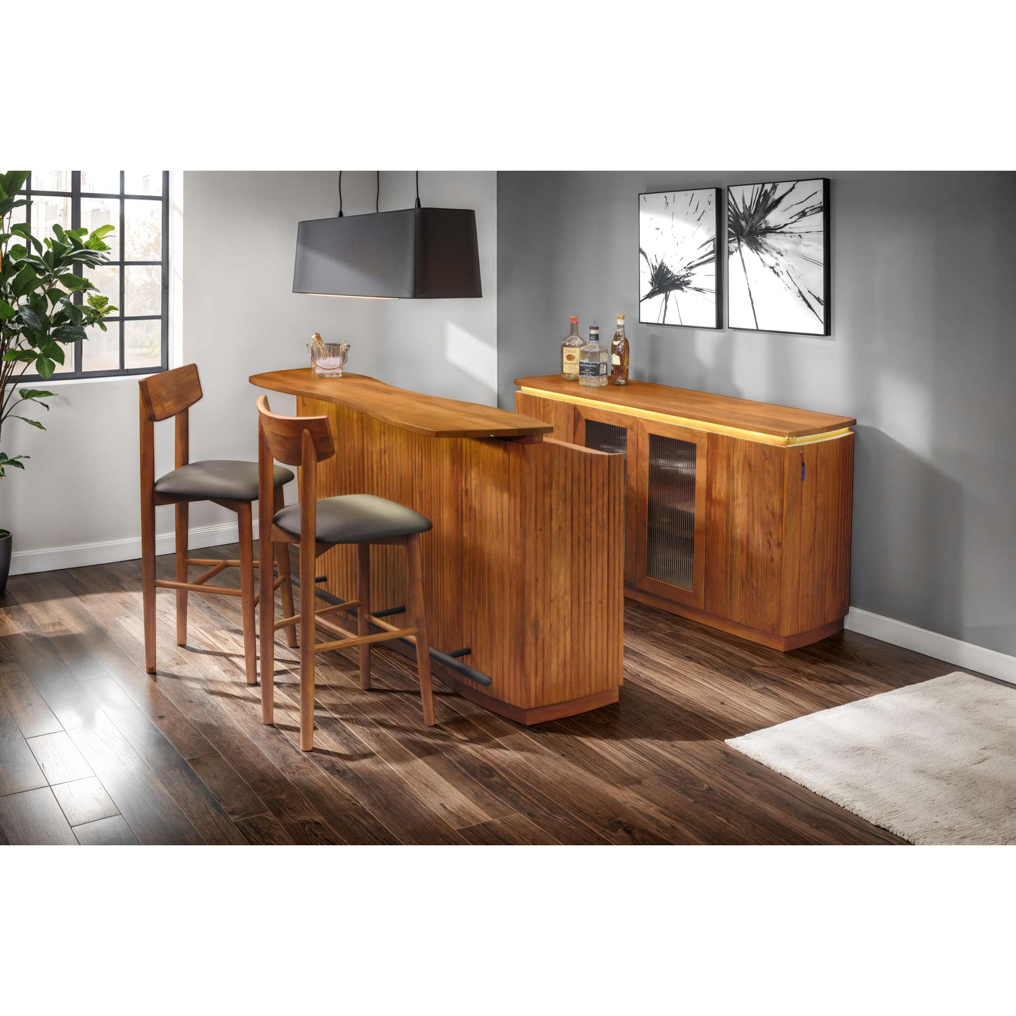 Modern wooden home bar with two stools and decorative wall art.