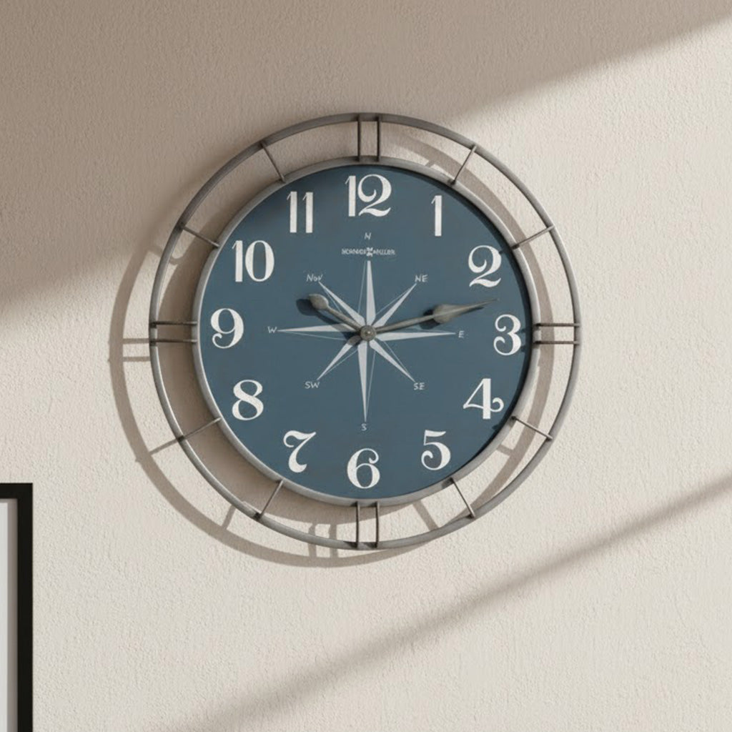 Nautical blue wall clock with large white numbers and compass design, perfect for home decor.
