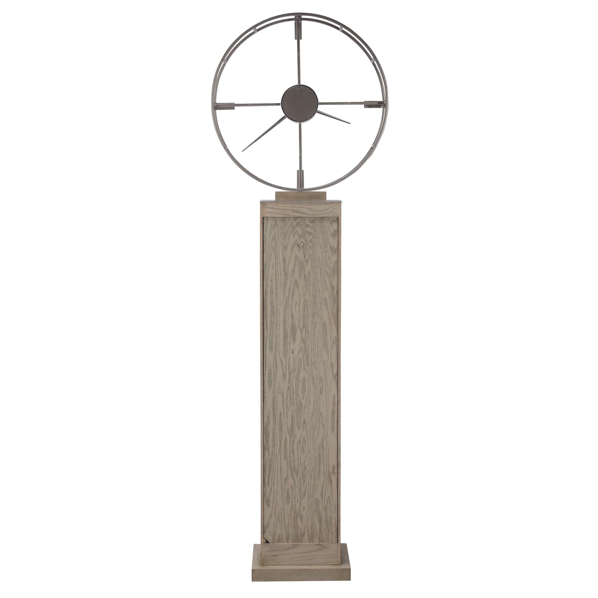 A decorative sculpture featuring a circular element atop a textured pedestal.