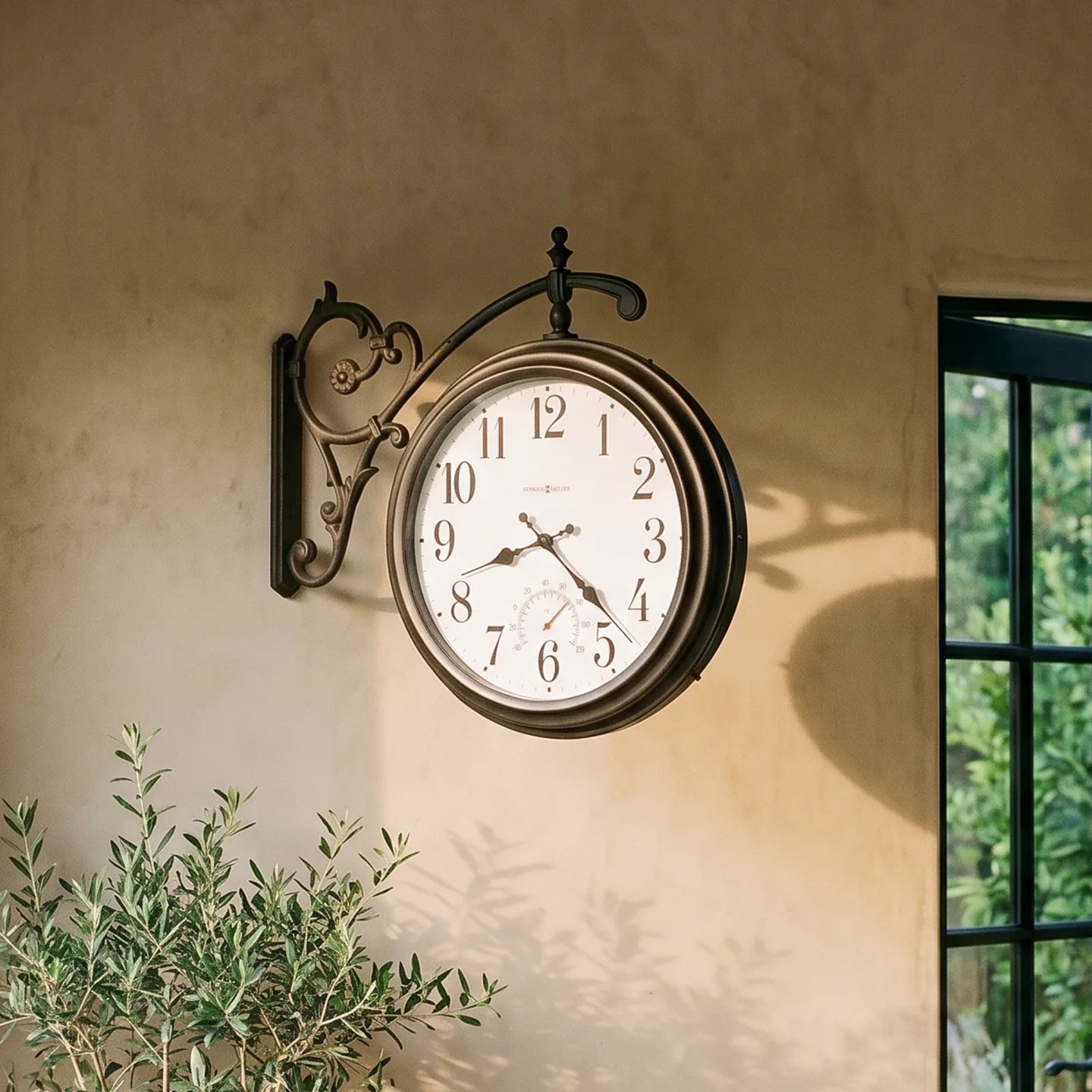 Howard Miller Luis Indoor/Outdoor Wall Clock, 22-inch, on the wall in a styled room
