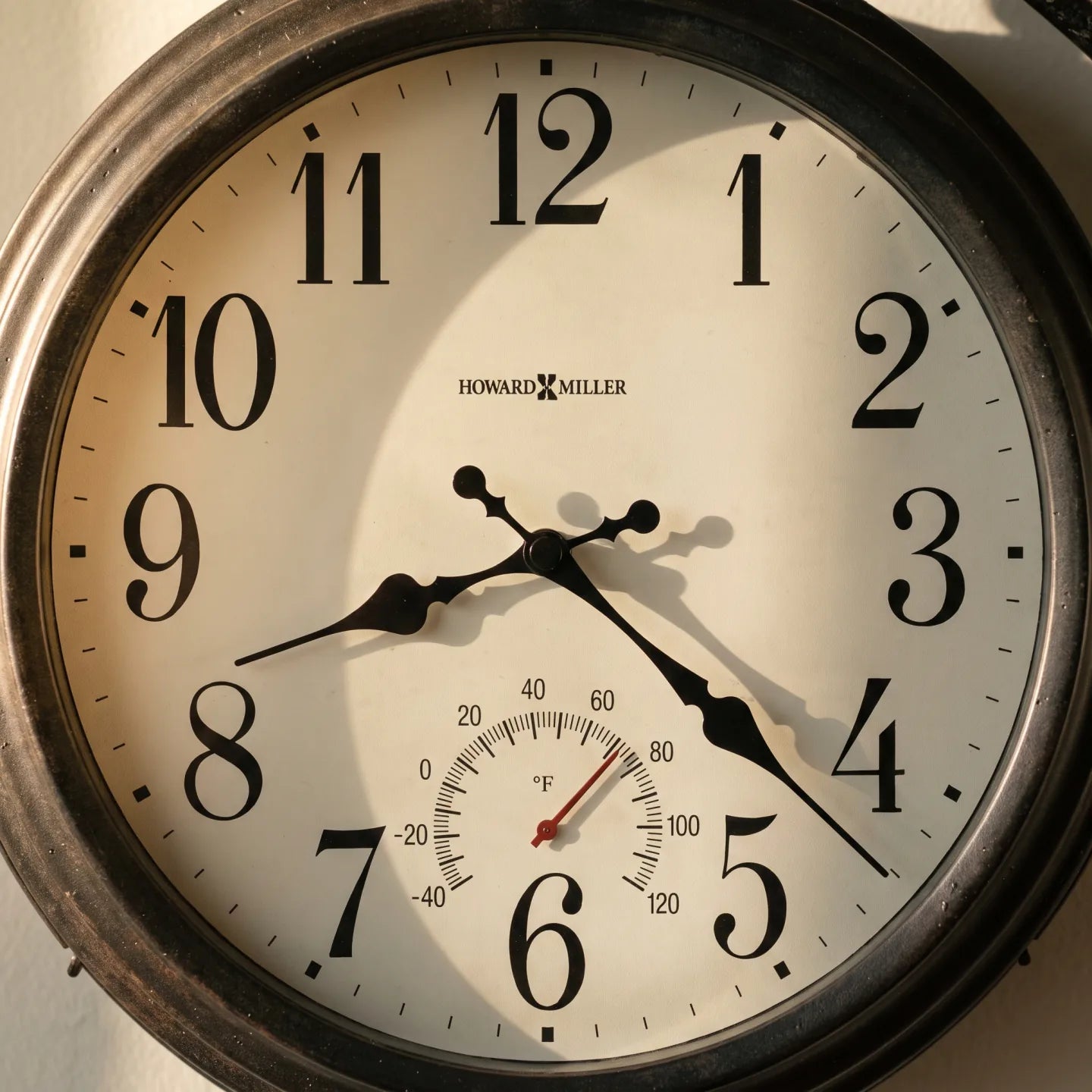 Howard Miller Luis Indoor/Outdoor Wall Clock, close-up of the dial and finish detail