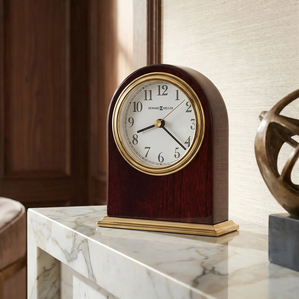 Howard Miller Monroe Tabletop Clock, 5-inch, on a shelf in a styled room