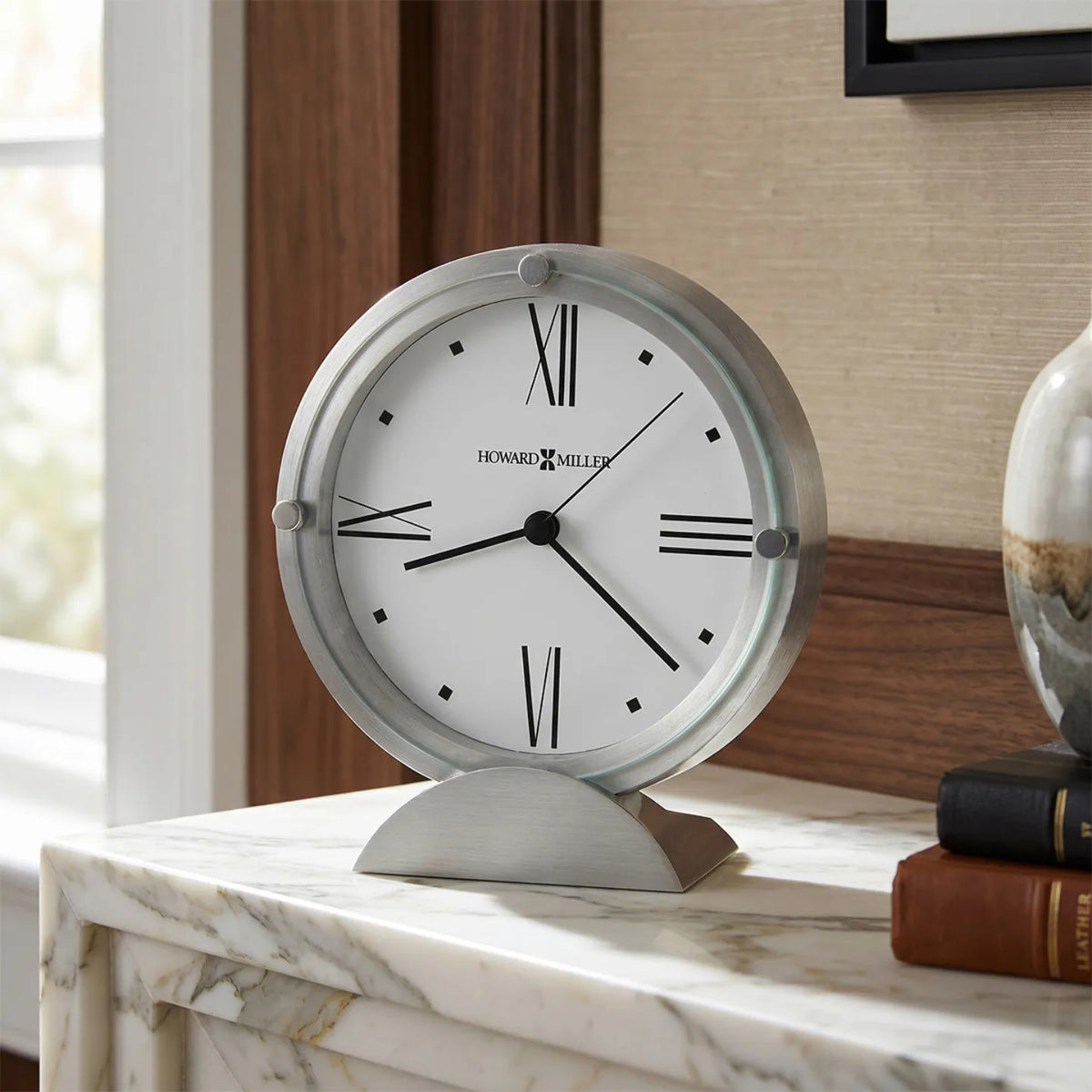 Howard Miller Simon II Tabletop Clock, 6-inch, on a shelf in a styled room