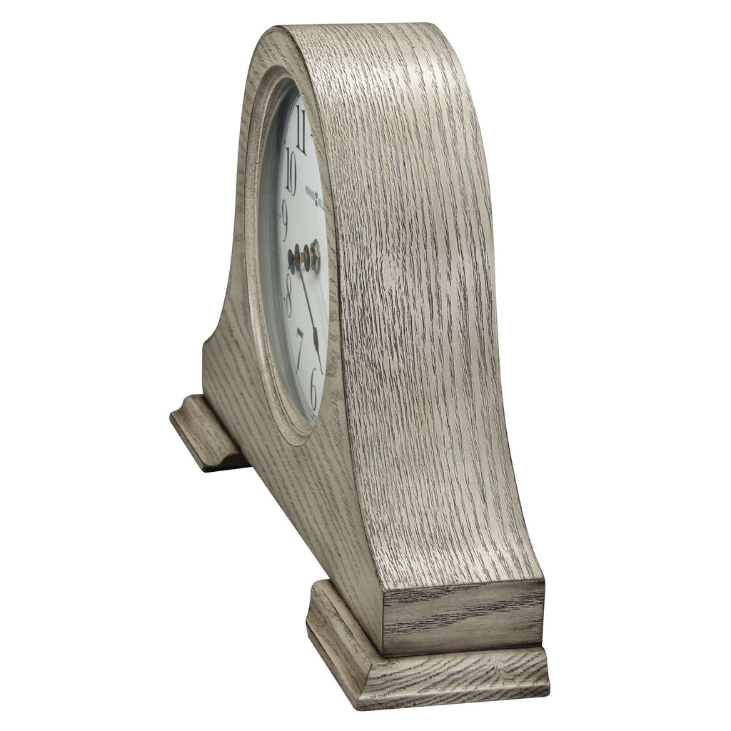 Side view of a vintage-style table clock with a wooden finish.