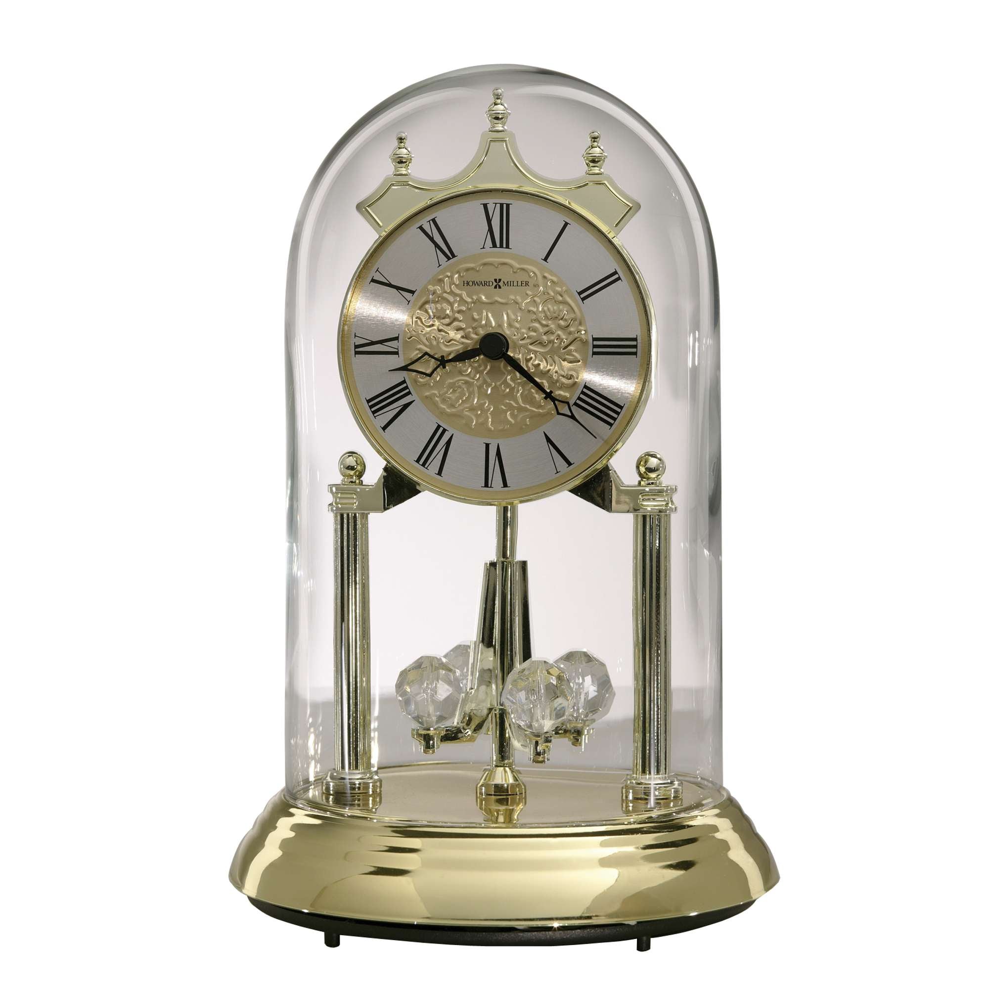A decorative clock inside a glass dome with a gold base and Roman numerals.