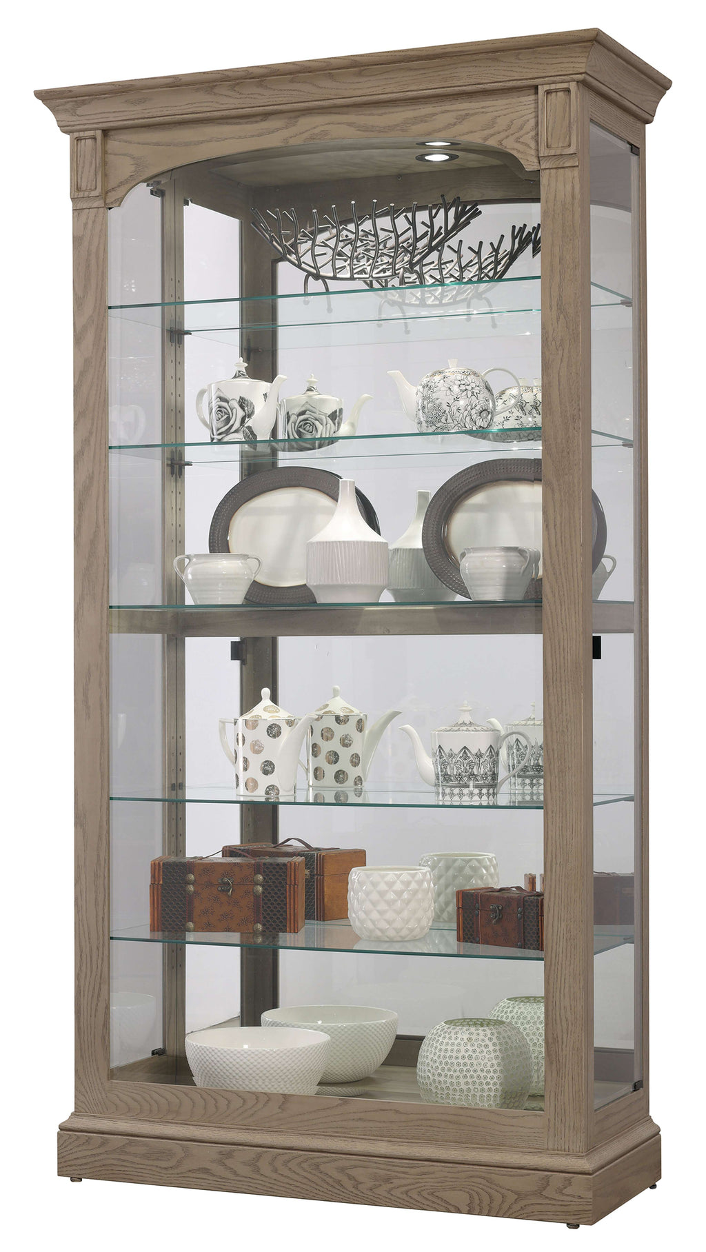 Display cabinet featuring glass shelves with various decorative dishes and teapots.