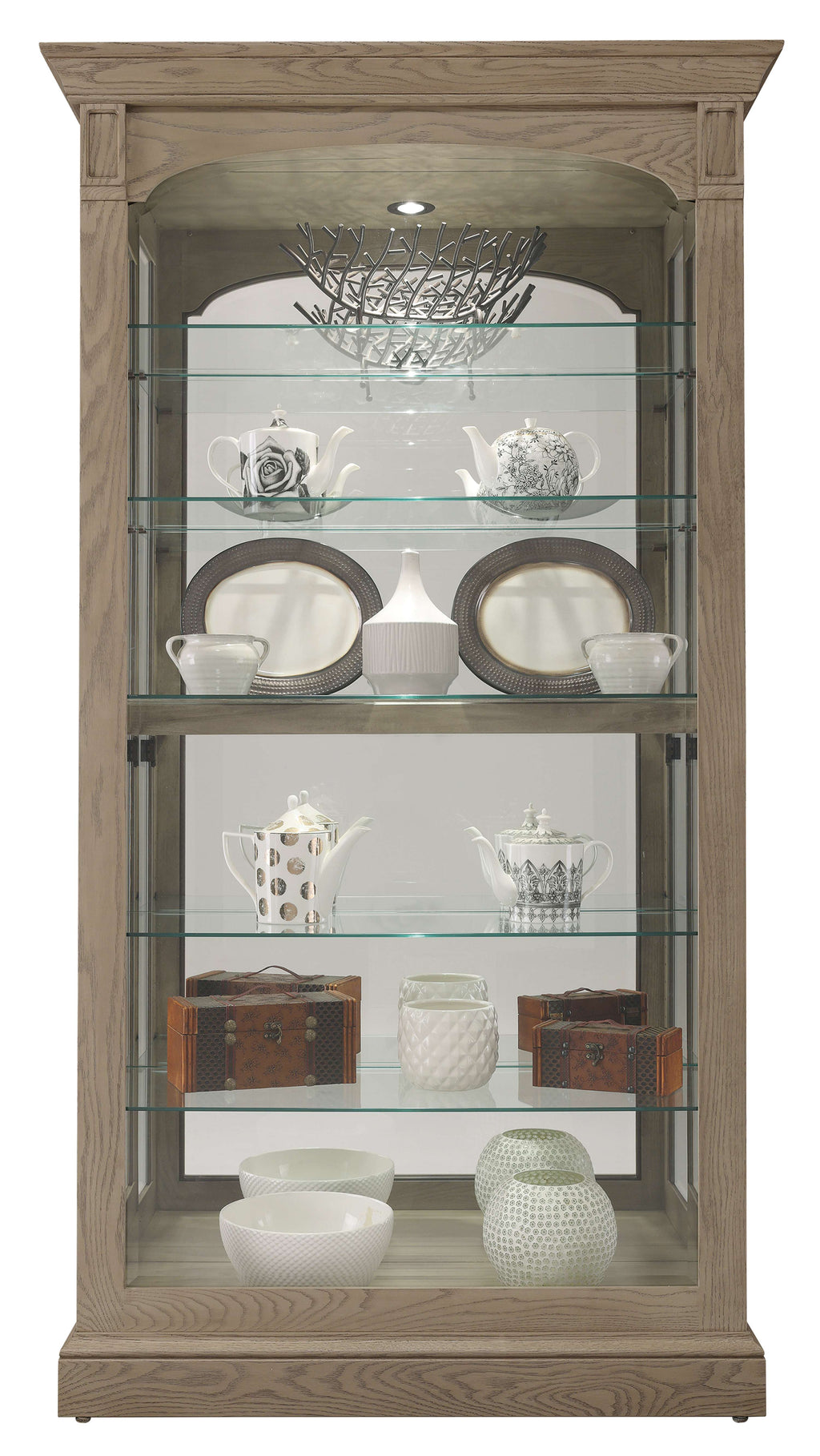 Glass display cabinet with various ceramic dishware and decorative items.