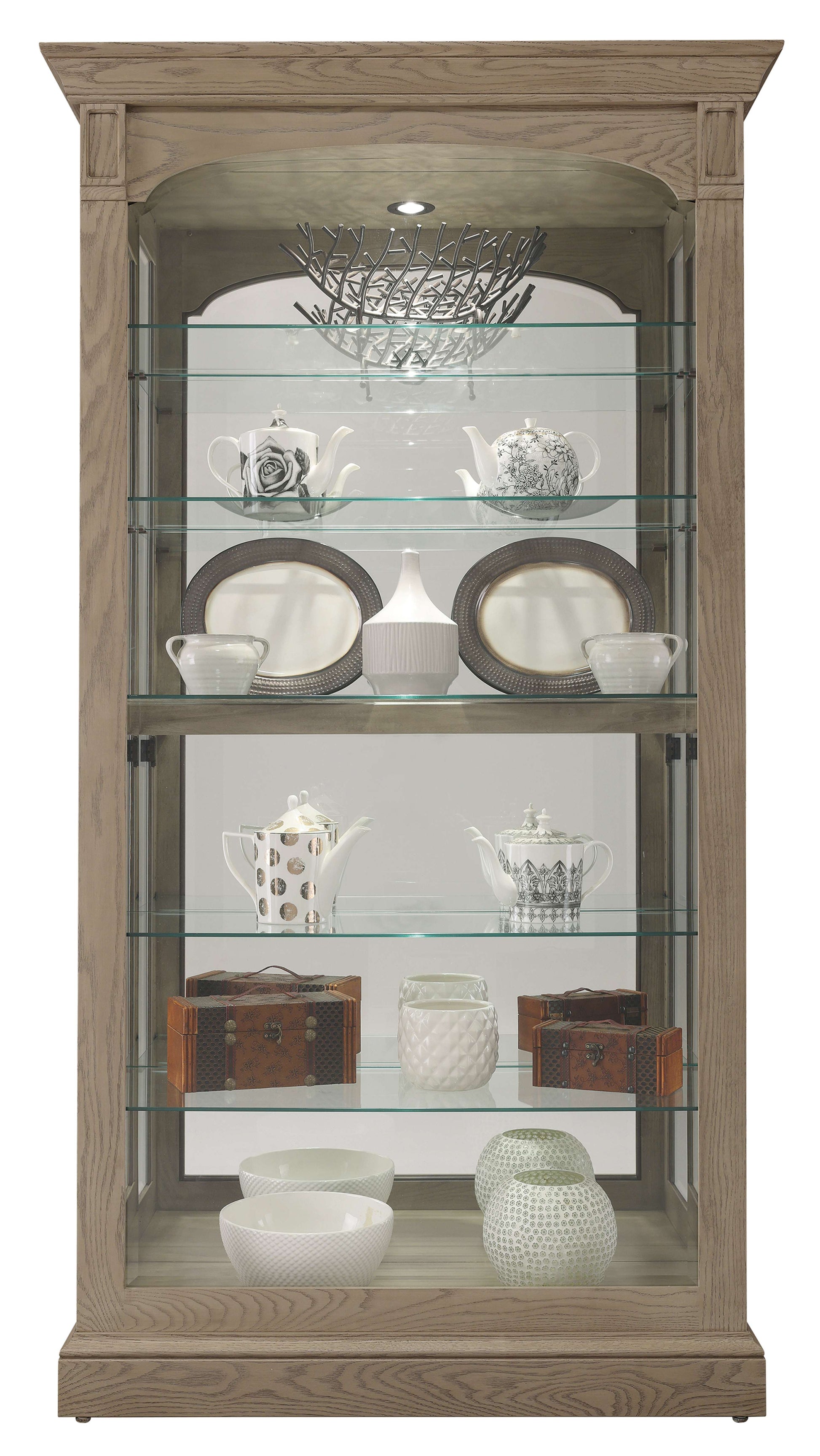 Glass display cabinet with various ceramic dishware and decorative items.