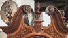 Close-up of an ornate wooden furniture piece with decorative carvings.