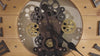 Close-up of a vintage clock mechanism with visible gears and clock hands.