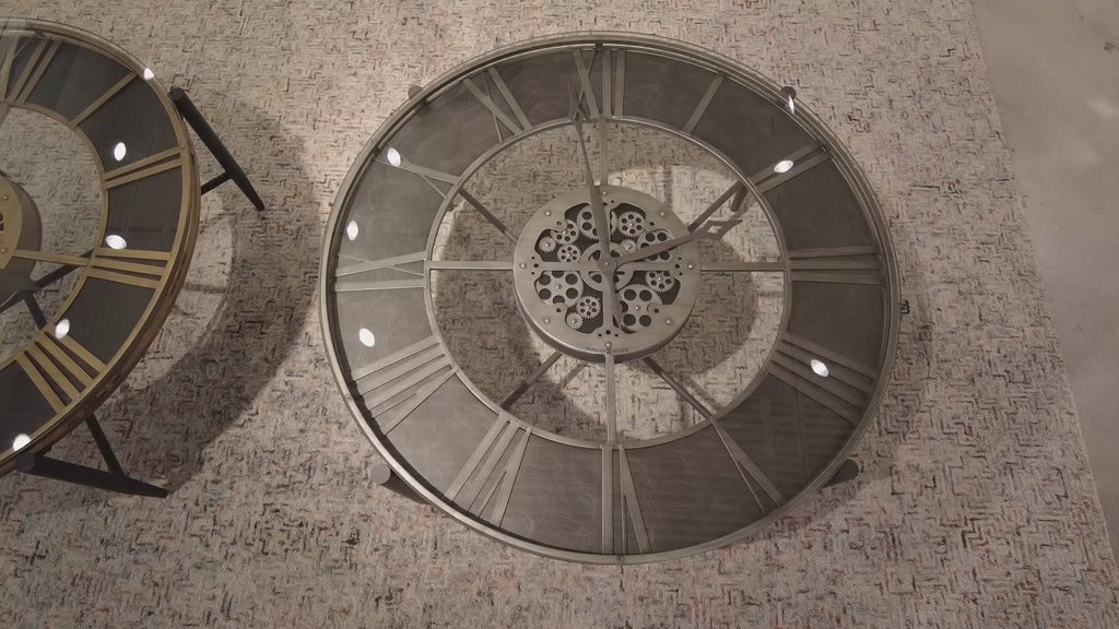 Top view of two intricate circular clock mechanisms on a textured surface.