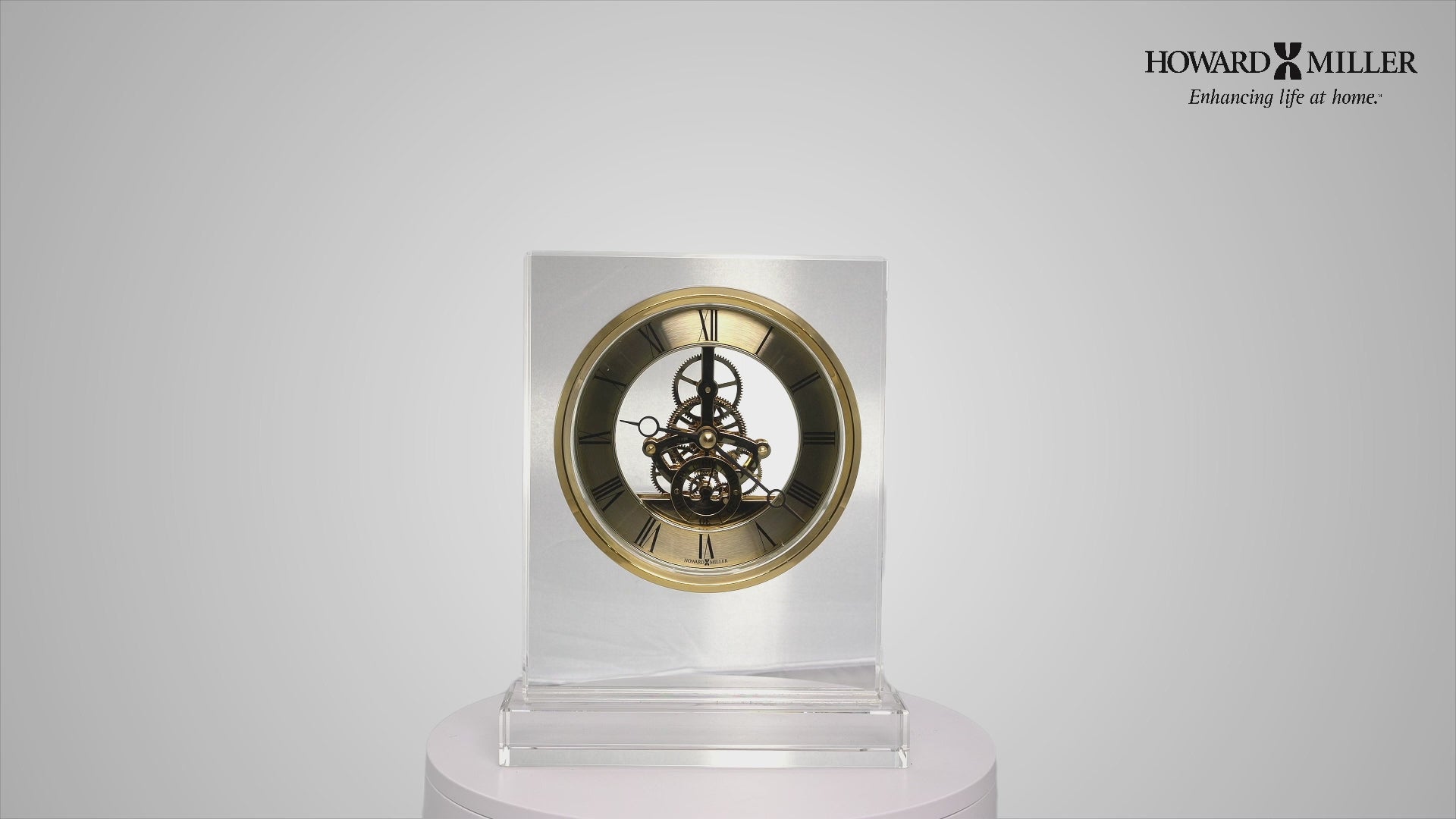 A decorative clock displayed on a pedestal, featuring a detailed design with gears and a gold-tone face.