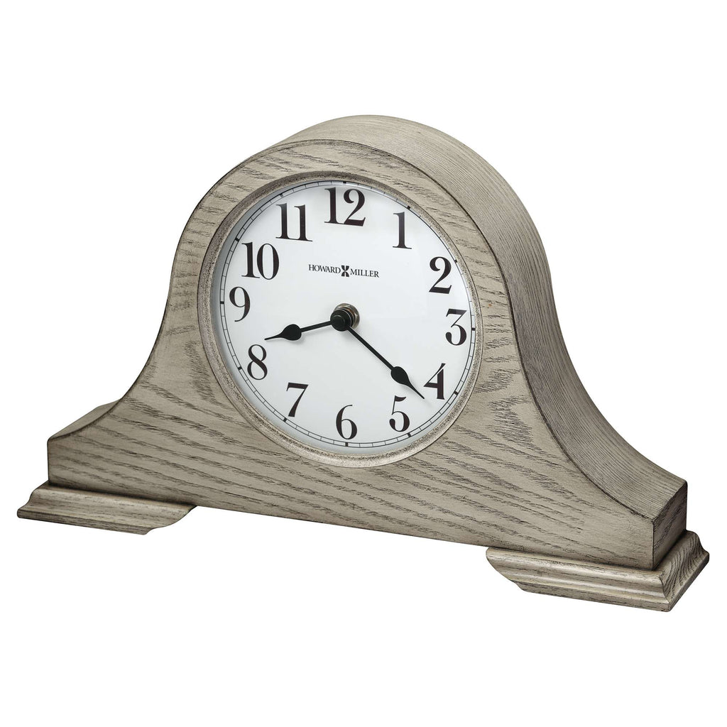 A decorative tabletop clock with a wooden frame and a white clock face.